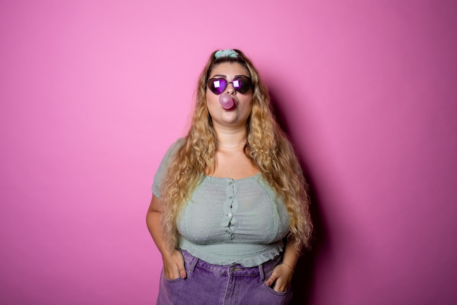 Caucasian Chubby Young Woman Blows Bubble From